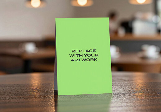 Vertical card mockup displayed on a wooden table in cafe setting with blurred background, realistic stationery presentation for branding, graphic design, advertising or print media