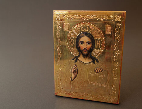 An old icon depicting Jesus Christ against a dark background; an icon as a symbol of Christianity.