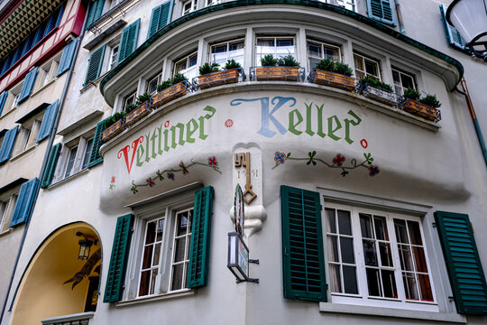 Zurich, Switzerland - March 15, 2026. A low-angle exterior shot captures the historic facade of the Veltliner Keller restaurant in Zurich, Switzerland. The building features an ornate bay window struc