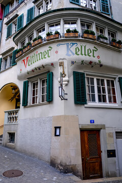 Zurich, Switzerland - March 15, 2026. A low-angle exterior shot captures the historic facade of the Veltliner Keller restaurant in Zurich, Switzerland. The building features an ornate bay window struc