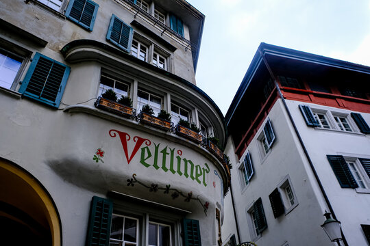 Zurich, Switzerland - March 15, 2026. A low-angle exterior shot captures the historic facade of the Veltliner Keller restaurant in Zurich, Switzerland. The building features an ornate bay window struc