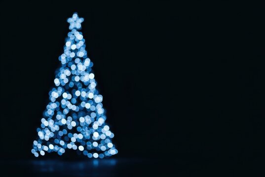 Abstract Blue Christmas Tree with Bokeh Lights on Dark Background for Holiday Greeting Card Design