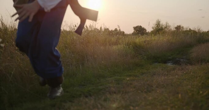 Caucasian man with long hair and Ukrainian traditional folk attire run away being chased . 4K 10-bit