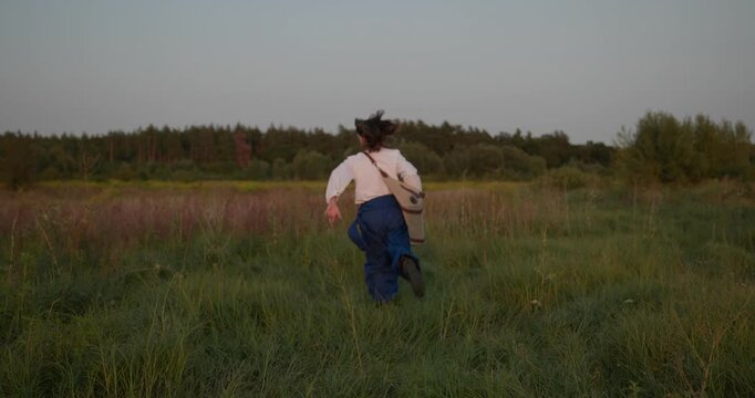 Caucasian man with long hair and Ukrainian traditional folk attire run away being chased . 4K 10-bit