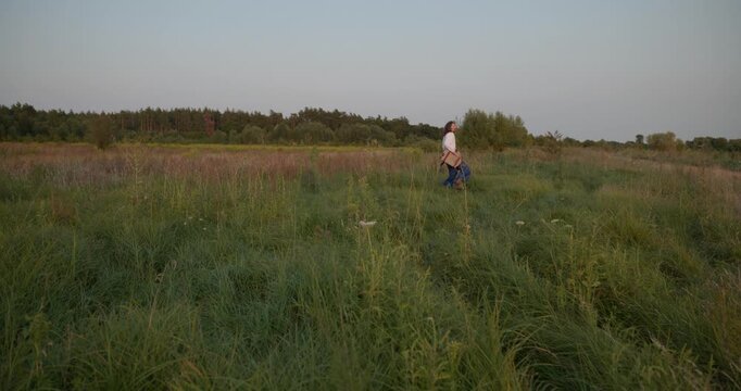 Caucasian man with long hair and Ukrainian traditional folk attire run away being chased . 4K 10-bit