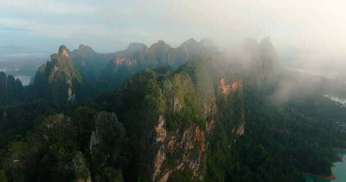 Sunrise Mist Over Cheow Lan Lake and Limestone Mountains &ndash; Khao Sok National Park, Thailand