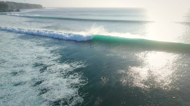 Drone view with ocean waves and surfers in ocean on Impossibles beach. Surfing and waves
