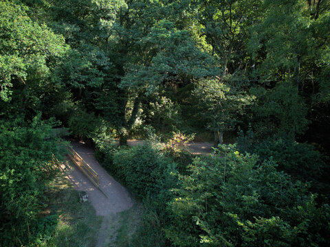 Aerial drone view of Holy Austin Rock Houses at Kinver Edge, Staffordshire, England. Birds-eye perspective of the historic troglodyte cave dwellings carved into red sandstone cliffs.