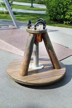 Wooden carousel for three children on a clear sunny day. Playgrounds, sports, health, entertainment.