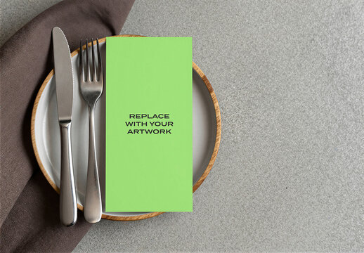 Vertical brochure mockup on a dining table setting with cutlery and napkin, realistic stationery presentation for graphic design, branding, or advertising display, Template, top view flat lay