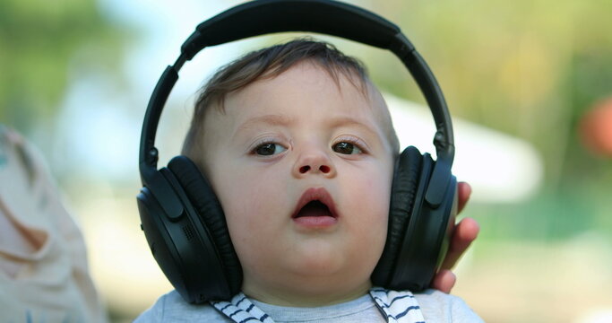 Baby with heaphones listening to music for first time