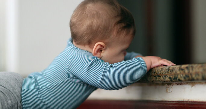 Baby learning to climb doorstep stair. Infant toddler development and effort