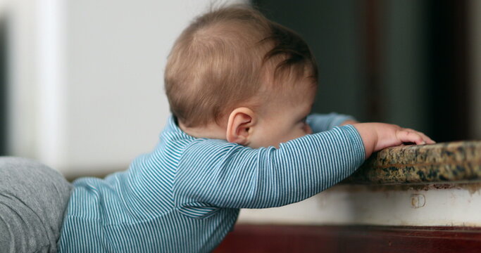 Baby learning to climb doorstep stair. Infant toddler development and effort