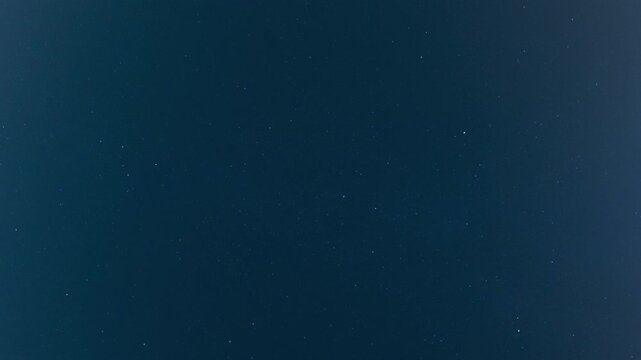 Deep blue night sky filled with countless twinkling stars, creating a beautiful cosmic scene and vast universe background