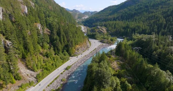 Mountains covered in forest, a river and Sea to Sky Highway between them. Canada