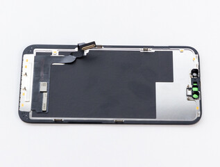 Disassembled Smartphone Screen With Internal Components on White Background