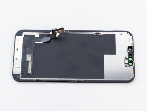 Disassembled Smartphone Screen With Internal Components on White Background