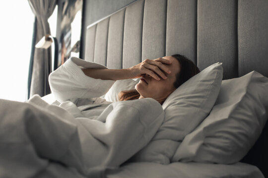 Young woman waking up in the morning feeling tired suffering from insomnia bad sleep	