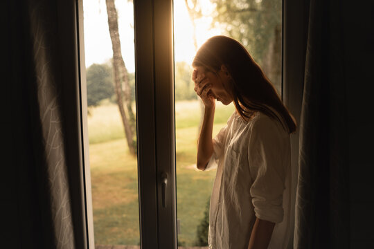 Young woman feeling depressed sad in a dark room 