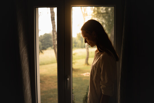 Sad young woman in a dark room	