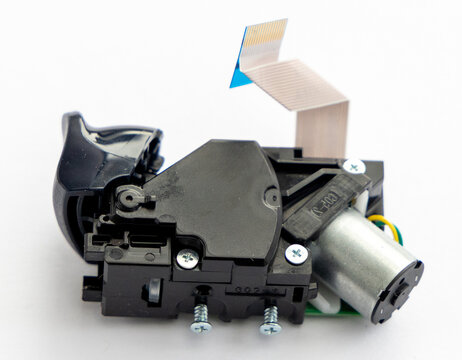 Electronic component with motor, circuit, ribbon cable, and plastic housing
