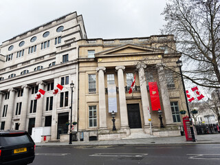 Fototapeta premium Canadian High Commission facade with maple leaf flags on a London UK street