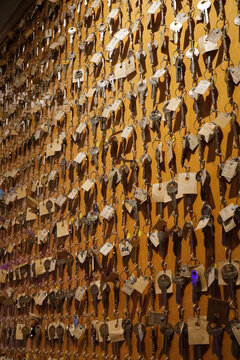 Collection of Old Keys Hanging on a Wooden Board with Paper Tags