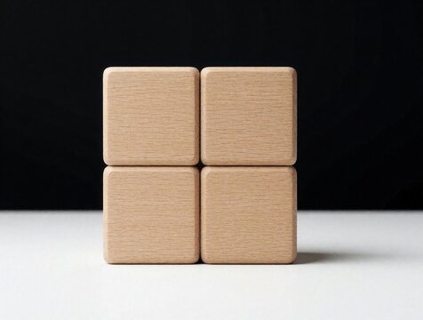 Four empty wooden cubes arranged in square shape on white surface. Light brown wood blocks form 2x2 grid against dark black background. Blank timber cubes serve as mockup template for text, logo,