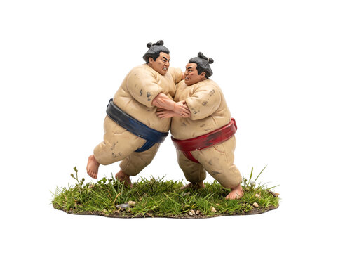Sumo wrestlers fighting wrestling match figurine, two Japanese traditional athletes grappling on grass in intense competition, isolated sport action strength concept illustration on black background