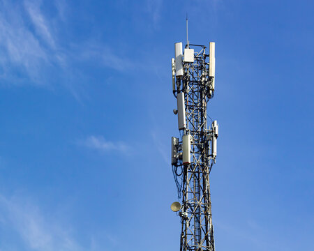 Telecommunication Tower Base Transceiver Station with Antennas Under Blue Sky