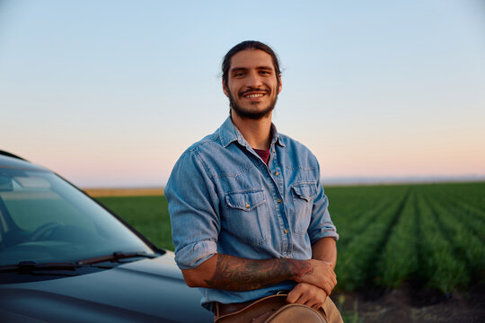 Portrait of happy agricultural field owner looking at camera.