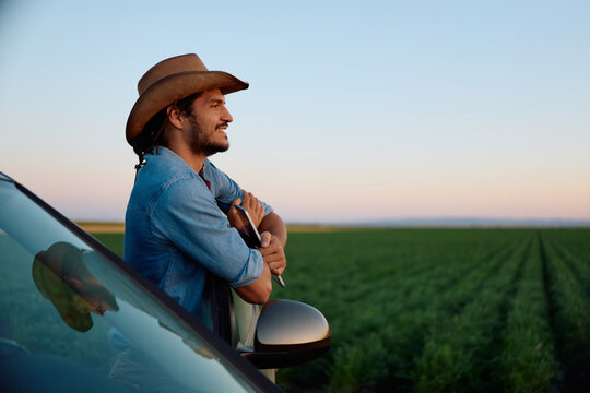 Satisfied agricultural worker looking across his farmland.
