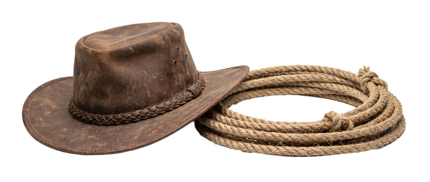 Leather cowboy hat coiled rope isolated on black background for western rodeo style country adventure themes, vintage rustic equipment isolated studio shot cutout design element object.