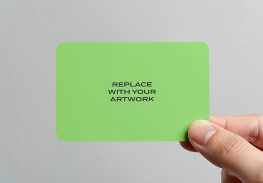Business card mockup held in hand against neutral background, realistic stationery presentation with placeholder text for branding and graphic design, template print identity