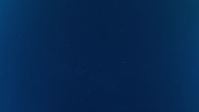 Deep blue night sky presenting numerous twinkling stars, creating a celestial background for astronomy and space themes