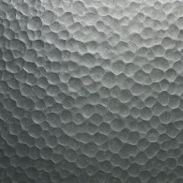 Hammered metal texture with dimpled surface and gradient lighting