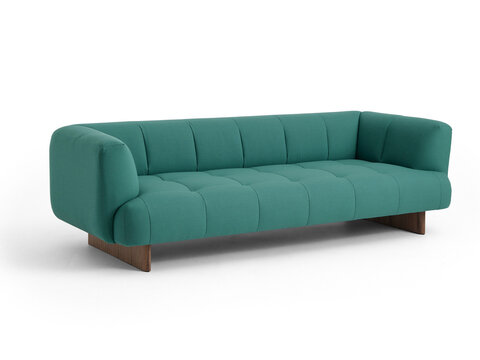 Modern green fabric tufted sofa with wooden base isolated on white background