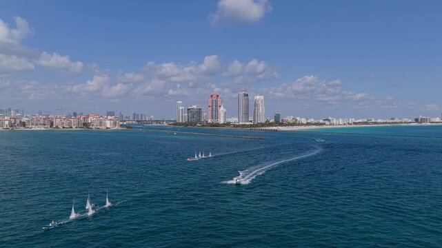 Miami sailing race. Sail training ship. Sailing boat at blue sky seascape. Ship sailing the sea. Sail boat at port of Miami. Travel by sea. Seascape horizon at sunset. Sea vacation. Sailboat vessel
