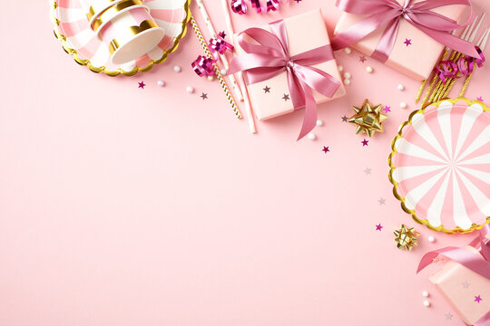 Pink birthday party frame with gifts and decorations top view