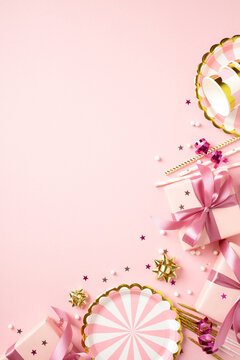 Birthday party accessories and gift boxes on pink background side