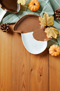 Ceramic mushroom plate with autumn decor on wooden table