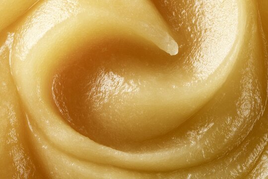 Creamy texture of a smooth spread seen in close up with swirls and patterns
