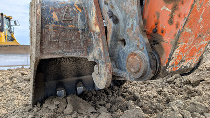 Fototapeta premium Excavator bucket with quick coupler on a construction site. 