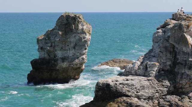 Scenic ocean waves crashing on rocky cliffs