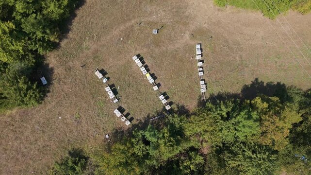 Top-Down Aerial View of Drone Descending Towards Apiary and Beehives in Bijela Near Konjic, Bosnia and Herzegovina