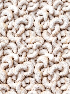 Traditional Austrian Vanillekipferl crescent cookies create a dense potrait oriented pattern and sugary texture for bakery marketing, food blogs, and festive seasonal menu designs.