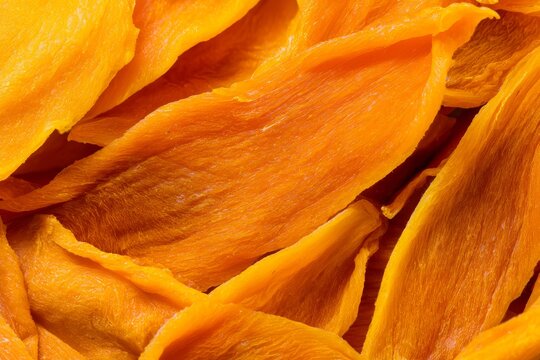 Dried mango slices arranged in a close-up view showing their texture and color