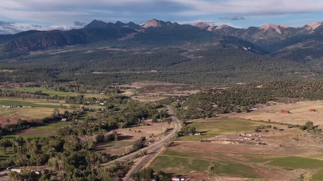 Wide aerial of mountain valley landscape in Mancos Colorado in summer of La Plata Mountains
