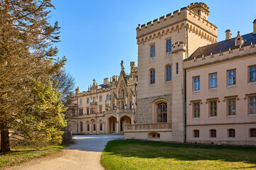 Fototapeta premium Historic european castle with gothic architecture under sunny sky