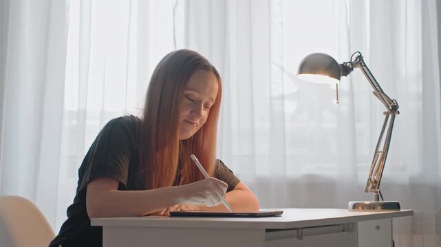 Young woman with long hair is seated at white desk focused. Woman wears dark clothing in each segment. Scene remains consistent throughout showing her engaged workspace